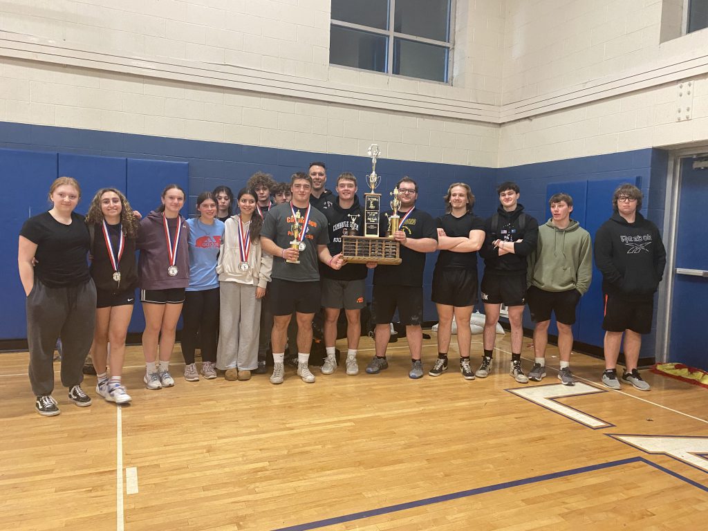 Boys and girls weightlifting teams holding the first place trophy.