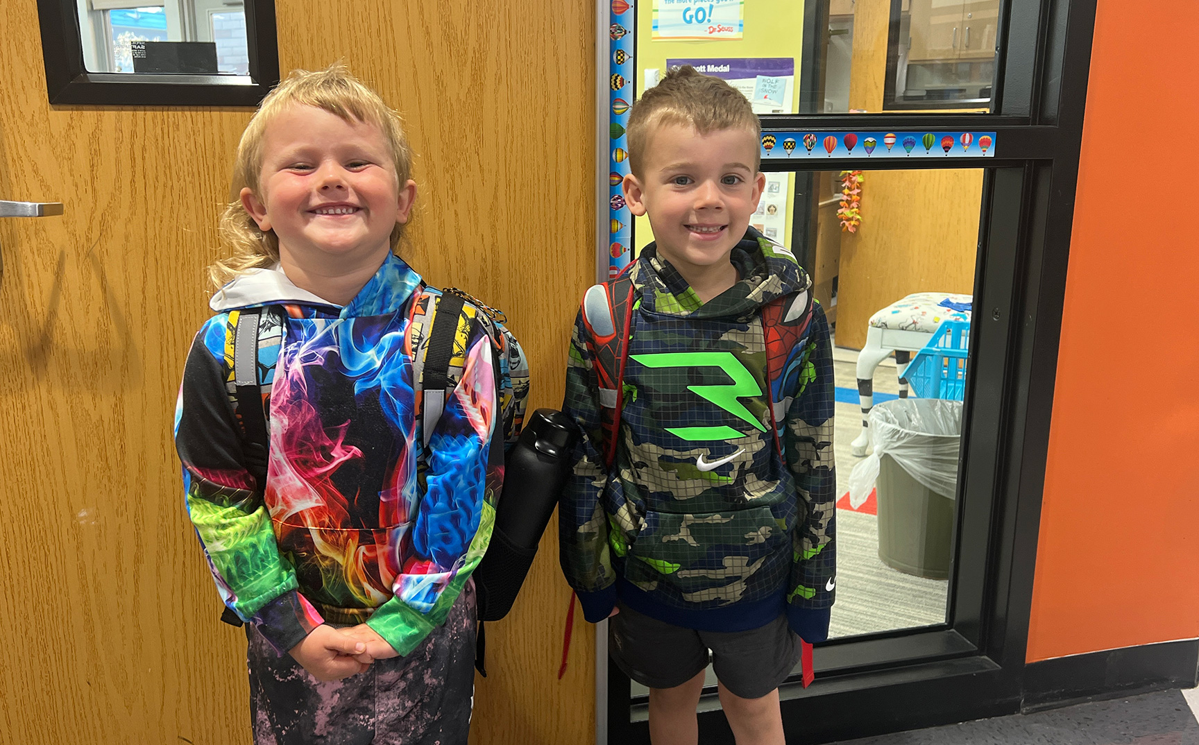 Elementary students posing in front of the library 