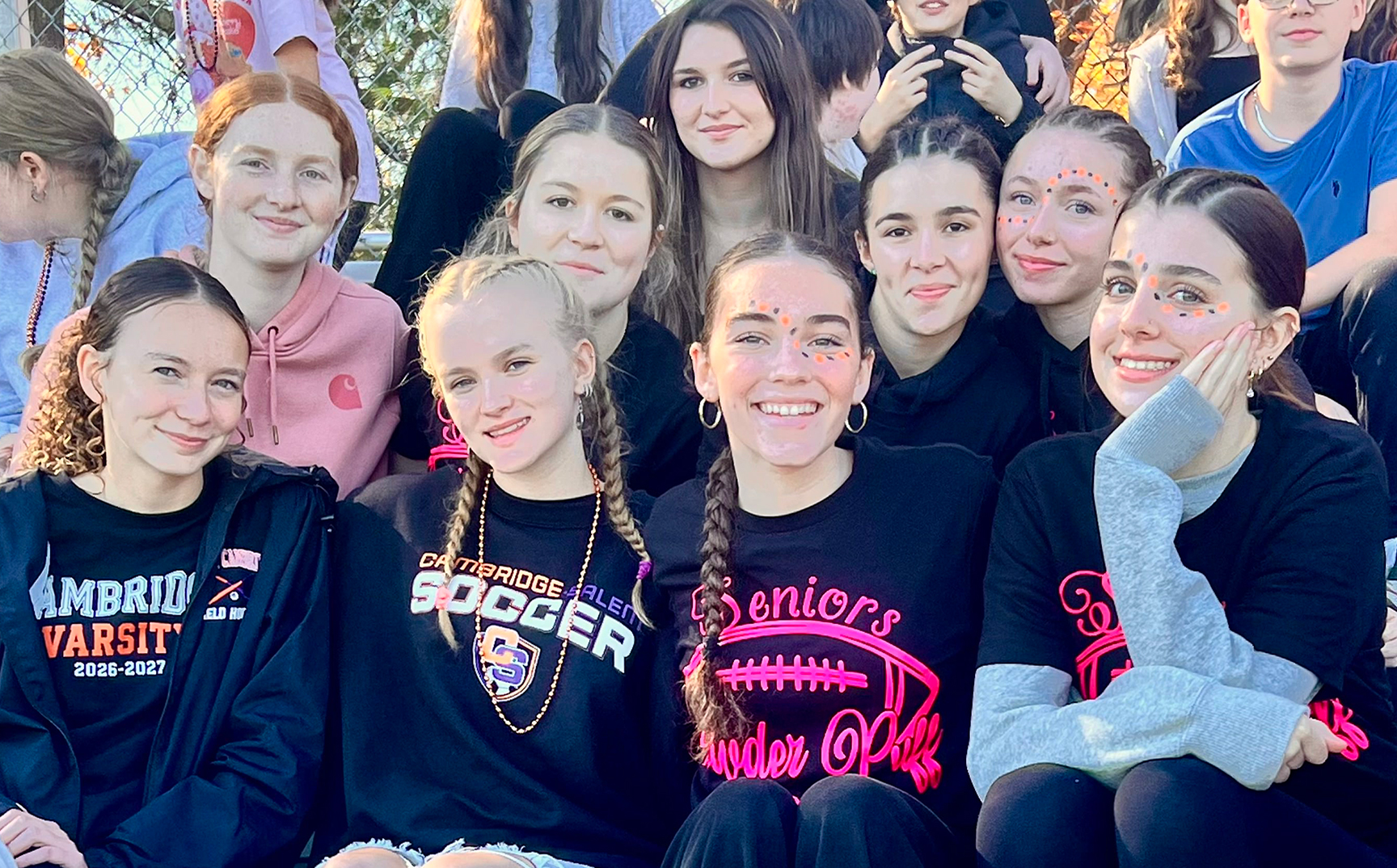 High school girls sitting on the bleachers at a pep rally